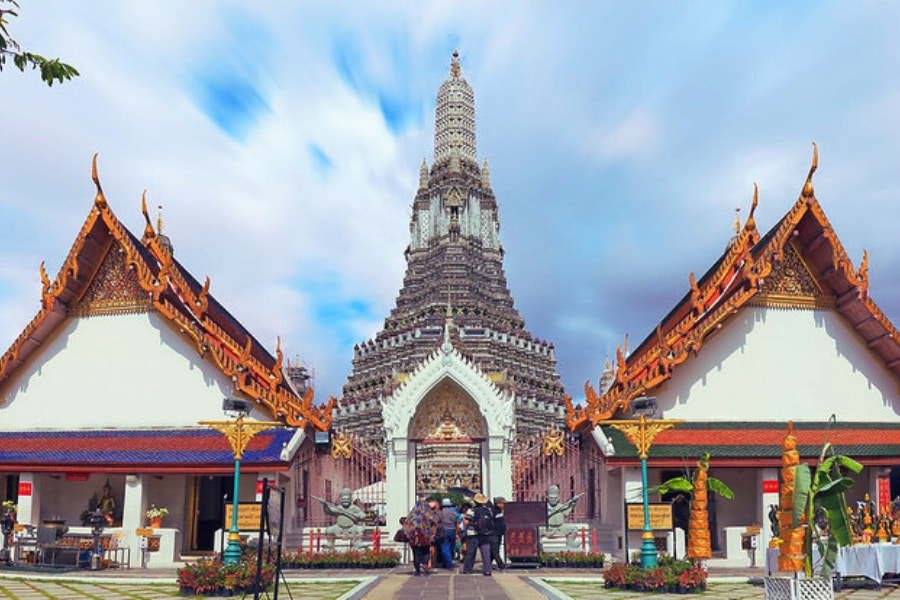 Wat Arun Temple in Bangkok Thailand with tourists visiting cultural landmark – Auasia Travel